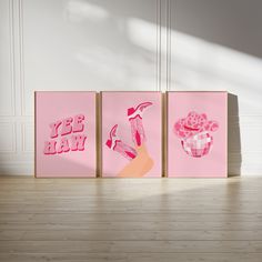 three pink paintings on wooden floors in an empty room