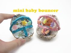 two miniature baby bouncer toys are being held by someone's hand with the caption, mini baby bouncer