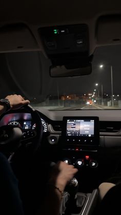 a man is driving his car at night