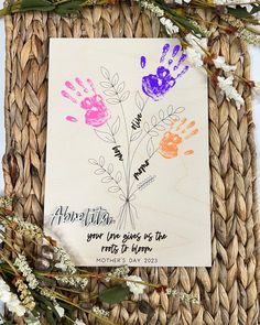 a handprinted card with flowers on it