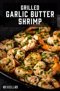 grilled garlic butter shrimp in a cast iron skillet with text overlay that reads grilled garlic butter shrimp