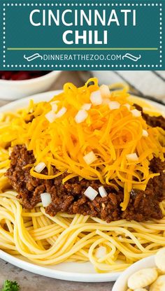 a white plate topped with spaghetti and cheese