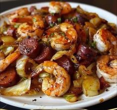 shrimp and sausage stir fry on a white plate