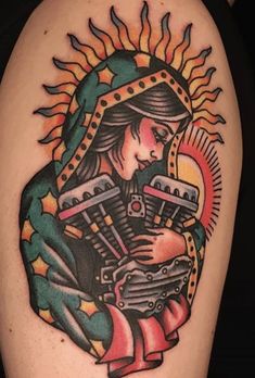 an old school style tattoo on the arm of a woman holding a baby in her arms