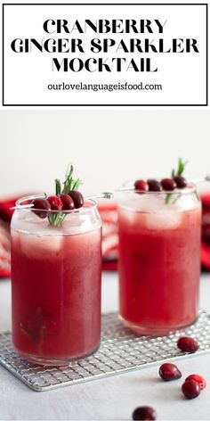 cranberry ginger sparkler cocktail is garnished with rosemary and cherries