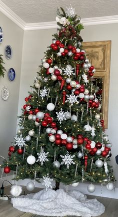 a decorated christmas tree with red and white ornaments