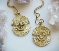 The Meg ~ Brass Medallion Pendant Necklaces feature a brass sunshine shape in raw brass with crushed mother of pearl and gold leaf flake embedded. Hangs on an 18" 20 or 24" brass ball chain. Details • Made in United States • Weight: 0 oz (0 g) • Dimensions: 1.5 x 1.5 x 18 in (3.8 x 3.8 x 45.7 cm) WHO IS CAMEOKO Camille Kohler is the sole artist and maker of cameoko jewelry that is a resin jewelry line that combines resin with crushed gemstones, metallic flakes, pigments for color and more. The l One Of A Kind Brass Medallion Jewelry, Artisan Gold Etched Jewelry, Artisan Etched Gold Jewelry, Unique Gold Etched Necklace, Handmade Brass Medallion Jewelry, Yellow Gold Etched Brass Necklaces, Artisan Gold Brass Necklace, Artisan Brass Necklace With Round Pendant, Yellow Gold Etched Brass Necklace