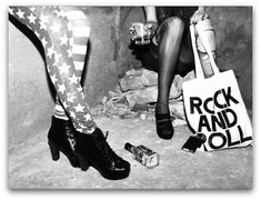 two women in tights and high heels with rock and roll bags