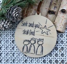 a wooden ornament with an image of two cats and the words see you and shall find