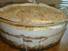 a casserole dish sitting on top of a wooden table next to a window