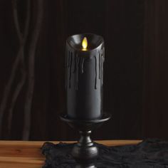 a black candle that is sitting on a table