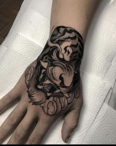 a person's hand with a tattoo on it