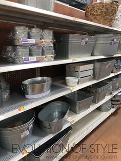 the shelves are full of buckets and containers for sale at the store, with baskets on each shelf