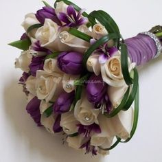 a bridal bouquet with purple and white flowers