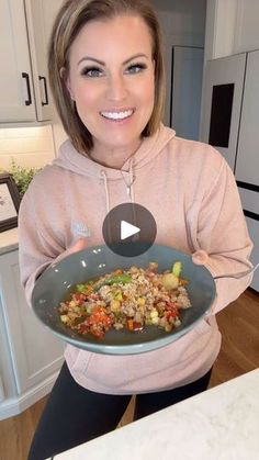 a woman holding a plate with food on it