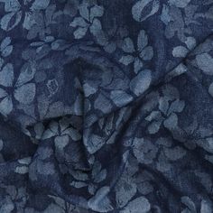 the fabric is blue with white flowers on it and has dark blue colors, as well as