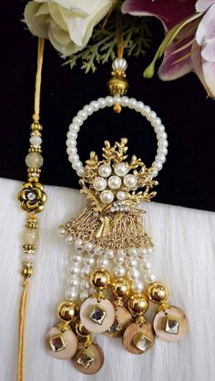 the necklace is adorned with pearls and gold beads