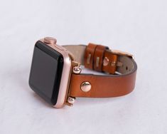 "8mm Genuine Slim Leather Apple Watch 9 Band Women with stainless steel buckle and adaptor will be a special piece in your collection.  This unique design iWatch leather bracelet jeweled with geometric cuts and contrasting stitches will make you look elegant. It will make a perfect match for various occasions including shopping, traveling, office work, sports, etc.  To see more, please click on  https://www.etsy.com/shop/MADUEMNEWYORK?ref=seller-platform-mcnav PRODUCT DESCRIPTION ● COMPATIBLE WITH all Apple Watch Series 9, Ultra, 8, SE, 7, 6, 5, 4, 3, 2, 1 & Sport  *Apple Watch is not included!   ● MADE OF 100% GENUINE FULL-GRAIN LEATHER, the highest grade leather money can buy. It develops a unique patina during its aging process, which will make this leather watch strap even more beautif Adjustable Rose Gold Watch Bands For Formal Occasions, Gold Leather Strap Apple Watch Band Gift, Gold Leather Strap Watch Bands For Gift, Gold Apple Watch Band With Leather Strap As Gift, Gold Leather Strap Watch Band As A Gift, Gold Leather Strap Watch Bands As Gift, Classic Adjustable Apple Watch Band As Gift, Apple Watch Style, Bracelet Apple Watch