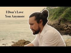 a man sitting on top of a rock next to the ocean with a quote above it