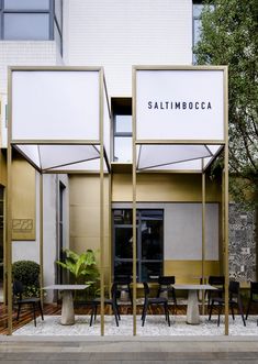 the outside of a restaurant with tables and chairs