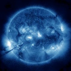 an image of the sun taken from space with blue lights on it's side