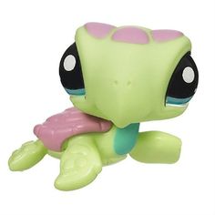 a littlest pet shop turtle toy with pink and green shell on it's back