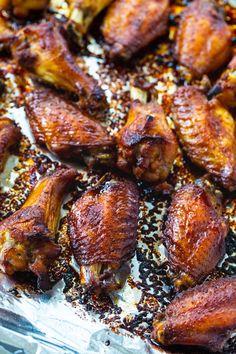 chicken wings with seasoning and pepper sprinkles on a sheet of tin foil