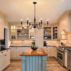 a large kitchen with an island in the middle and lots of cabinets on both sides