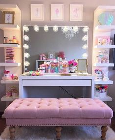 a pink bench sitting in front of a white desk with a mirror on top of it