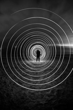 a man standing in the middle of a black and white photo with circles around him