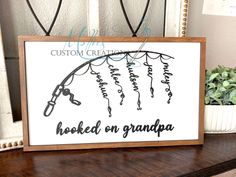 a wooden sign that says hooked on grandpa