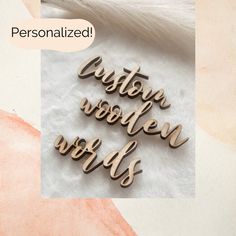 some type of wooden words on a white surface with a pink and orange background that says, custom wooden words