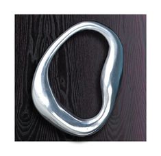 an image of a metal hook on a wooden door with dark wood in the background