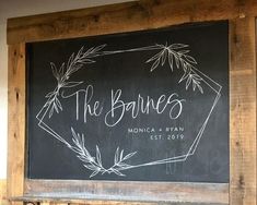 a chalkboard with the names of two couples on it in front of a wooden frame