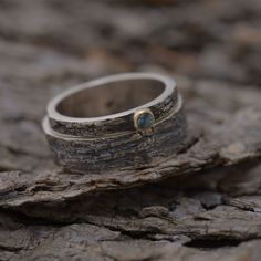 Unique set of two matching wedding rings inspired by the tree bark of an old olive family tree. Mixed precious metal rings made from sterling silver (men's band) and sterling silver and gold 14KT (women's band). On the top of womens band a natural gemstome of your choice is nested in 14KT gold. Custom made to your finger sizes. The price is for the set (two rings, one for the bride and one for the groom). The width of the men's band is 6mm and 2.5mm for the women's.Extremely strong and durable. Nature-inspired Hammered Jewelry For Anniversary, Nature-inspired Anniversary Rings With Polished Finish, Anniversary Nature-inspired Rings With Polished Finish, Nature-inspired Polished Jewelry For Anniversary, Nature-inspired Stackable Jewelry For Anniversary, Nature-inspired Stackable Jewelry For Anniversaries, Matching Wedding Rings, Wedding Band Sets, Tree Bark