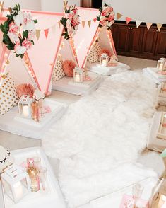 a room filled with pink and gold decorations on top of white fur covered flooring