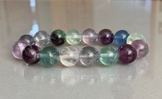 "Very pretty Natural Fluorite Crystal Bracelet with large 12 - 12.5mm Fluorite Beads. Made with high-quality adjustable elastic stretch cord. Please see item photos for proper wrist measurement before ordering. Fluorite cleanses and stabilizes the aura. It absorbs and neutralizes negative energy and stress. 💰BUY 3 GET 1 FREE💰 💰💎 Receive 25% off your entire order when you purchase 4 or more items. That's the equivalent of \"Buy 3 Get 1 Free\". Use DISCOUNT CODE: \"25OFF\" 💰💎 🚚 FREE U.S. Sh Fluorite Gemstone Bracelets With Round Beads, Spiritual Fluorite Bracelets With Gemstone Beads, Fluorite Gemstone Beads Bracelets For Healing, Fluorite Gemstone Beads Bracelet For Healing, Handmade Fluorite Beaded Bracelets As Gift, Bracelet Crystal, Fluorite Crystal, Bracelet Gemstone, Men's Bracelet