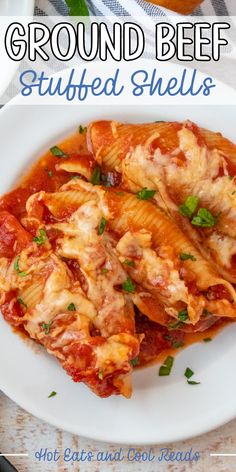 a white plate topped with stuffed shells covered in sauce