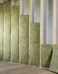 insulation in the corner of a room with wood flooring and walls covered in foam