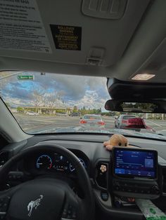 a stuffed animal sitting on the dashboard of a car