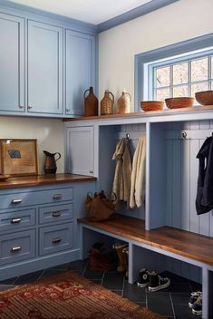 a kitchen with blue cabinets and wooden shelves