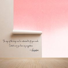 an empty room with a pink wall and a quote on the wall that says inspire