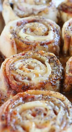 cinnamon buns with powdered sugar and sprinkles on top in a baking pan