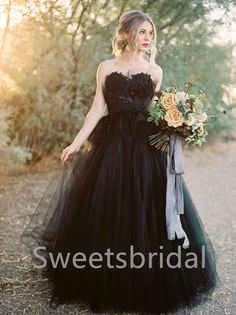 a woman in a black dress holding a bouquet