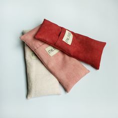 three pieces of red and white linen folded on top of each other, one with a label that says free