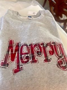 a sweater with the word merry on it