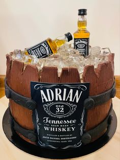 a birthday cake made to look like an old barrel with liquor bottles on the top