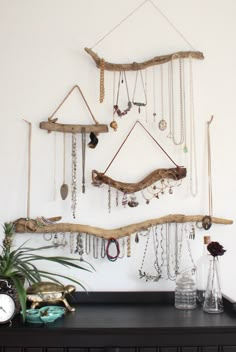 there is a wall hanging made out of driftwood and other items on the shelf