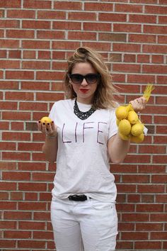 a woman holding lemons in front of a brick wall with the caption, 20 when life gives you lemons