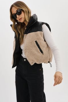 The MELICIA Reversible Puffer Vest is a stylish addition to your outerwear collection. With waist zip pockets for convenient storage and a reversible design, you have the flexibility to create different looks to suit your mood. On one side, you'll find a sleek full faux leather design, while the other side features a cozy combination of faux leather and faux sherpa. Everyday Winter Nylon Outerwear, Urban Everyday Outerwear With Zipper Closure, Urban Outerwear With Zipper Closure For Everyday, Trendy Everyday Outerwear With Zipper Closure, Black Zipper Closure Outerwear For Layering, Black Outerwear With Zipper Closure For Layering, Fall Weekend Outfits, Sherpa Vest, Winter Vest